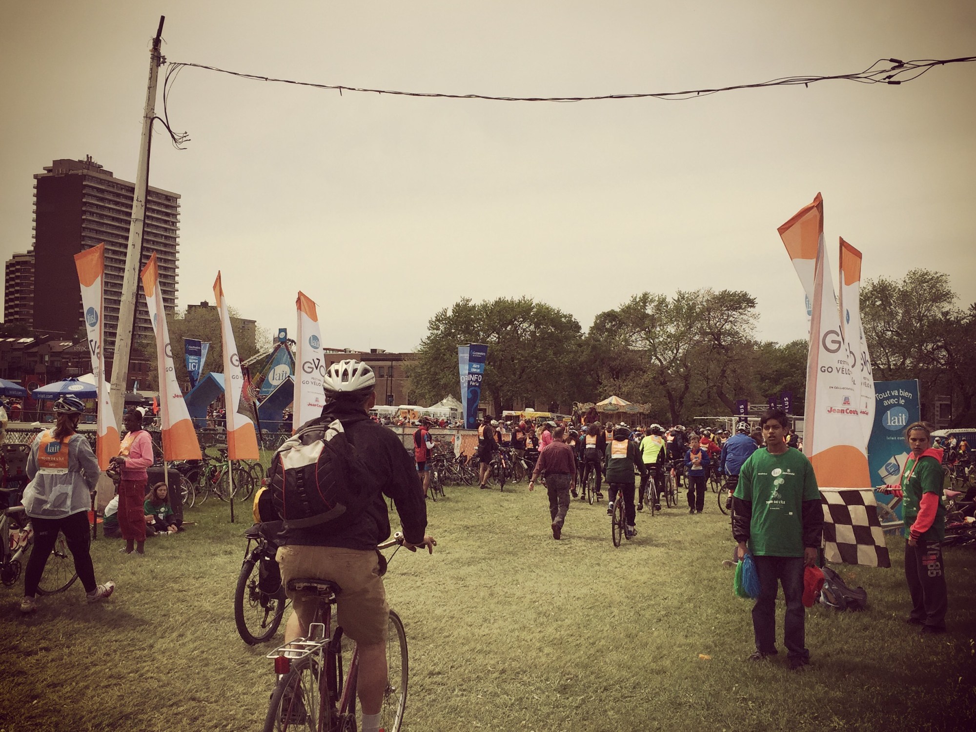 Cyclist riding through orange flags at the finish line