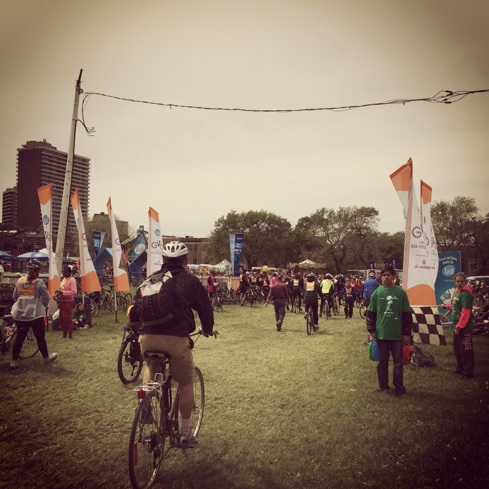 Cyclist riding through orange flags at the finish line